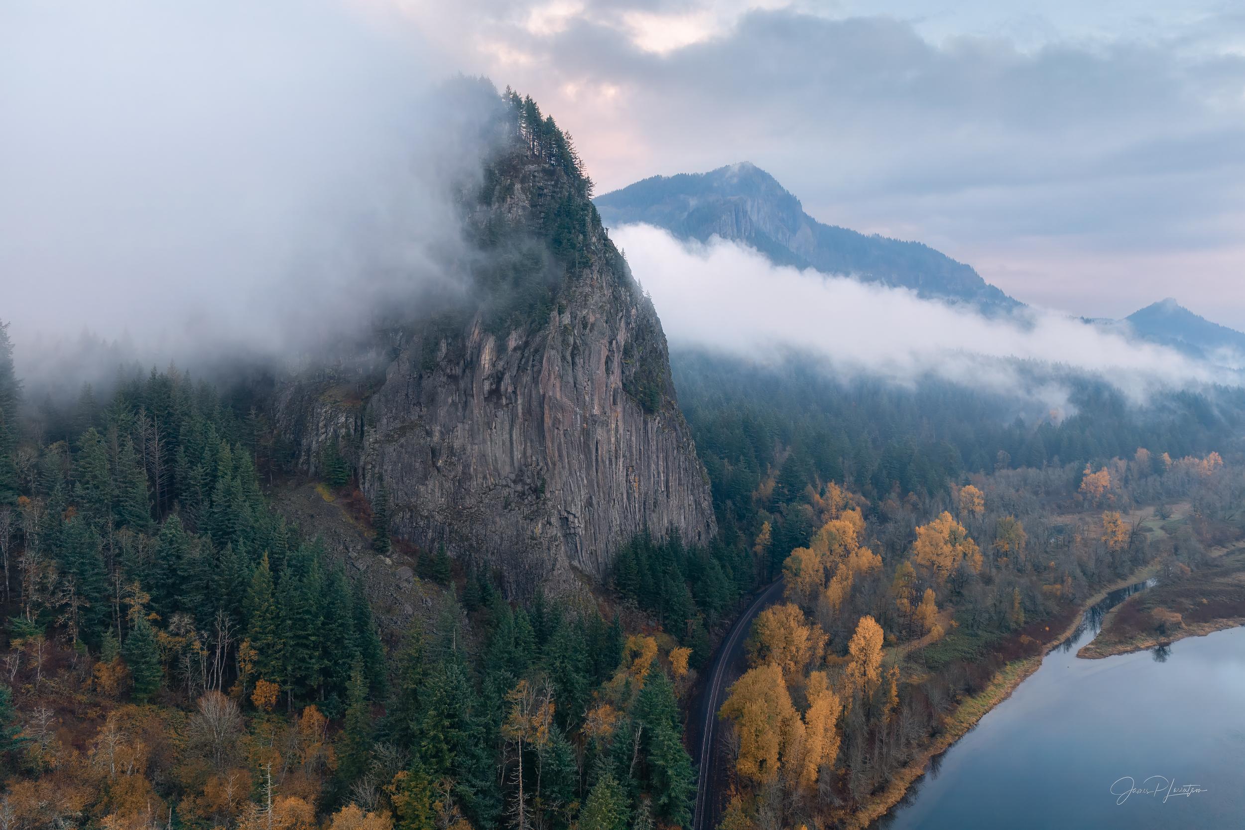 Low cloud wrapping Beacon Rock and the forested walls of the western Columbia River Gorge.