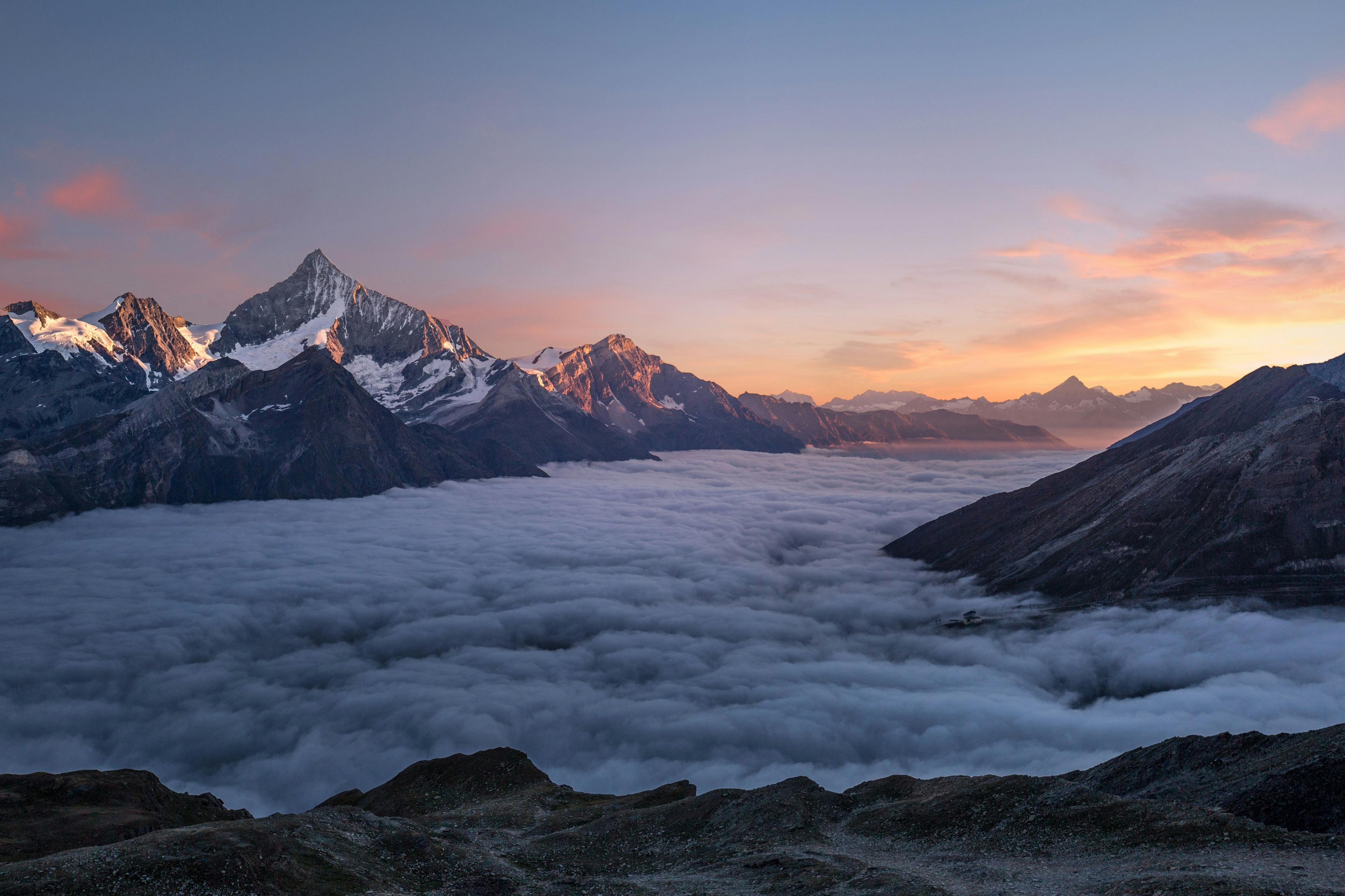 Fog blanketing a mountain range at sunrise