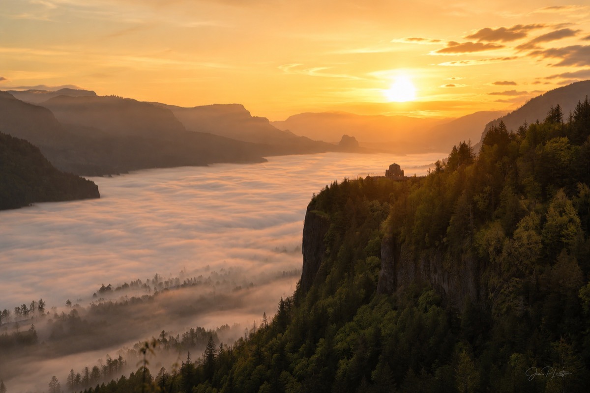 The same viewpoint with fog filling the valley during its peak month, shown as an illustrative composite